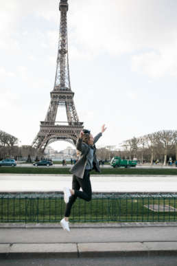 Photo of Stephanie Tusler in front of the Eiffel Tower in Paris, France