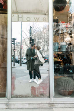 Photo of couple in mirror reflection kissing in Paris, France