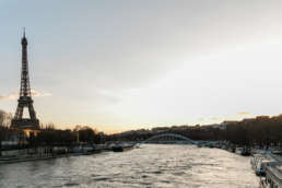 Photo of the Eiffel Tower next to a river in Paris, France