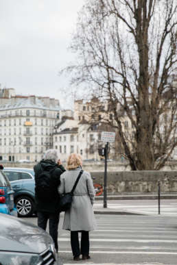 Photo of couple embracing in the streets of Paris, France