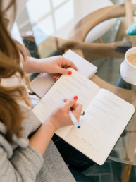 photo of woman writing in gratitude journal